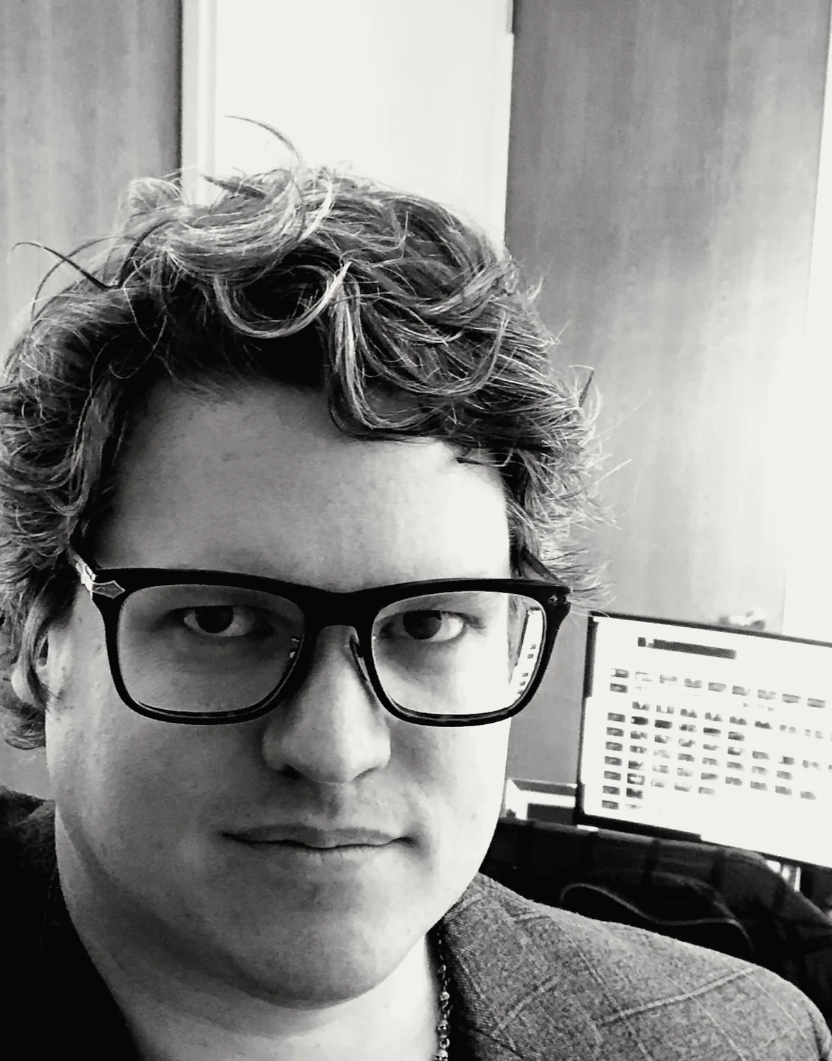 Arondale Withers — black-and-white portrait at the studio desk