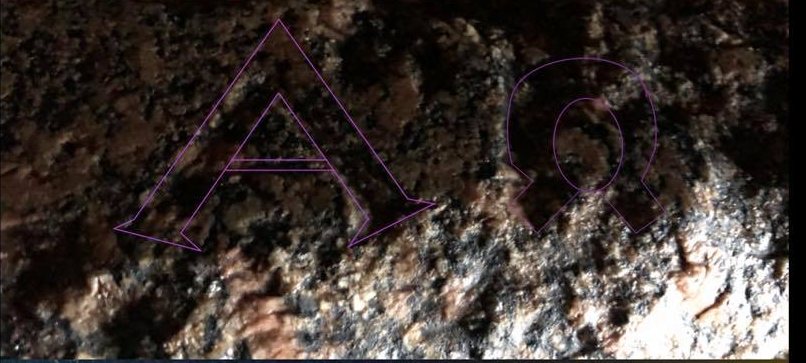The Alpha and Omega on the rim of the granite box, traced in violet over Grant's photograph