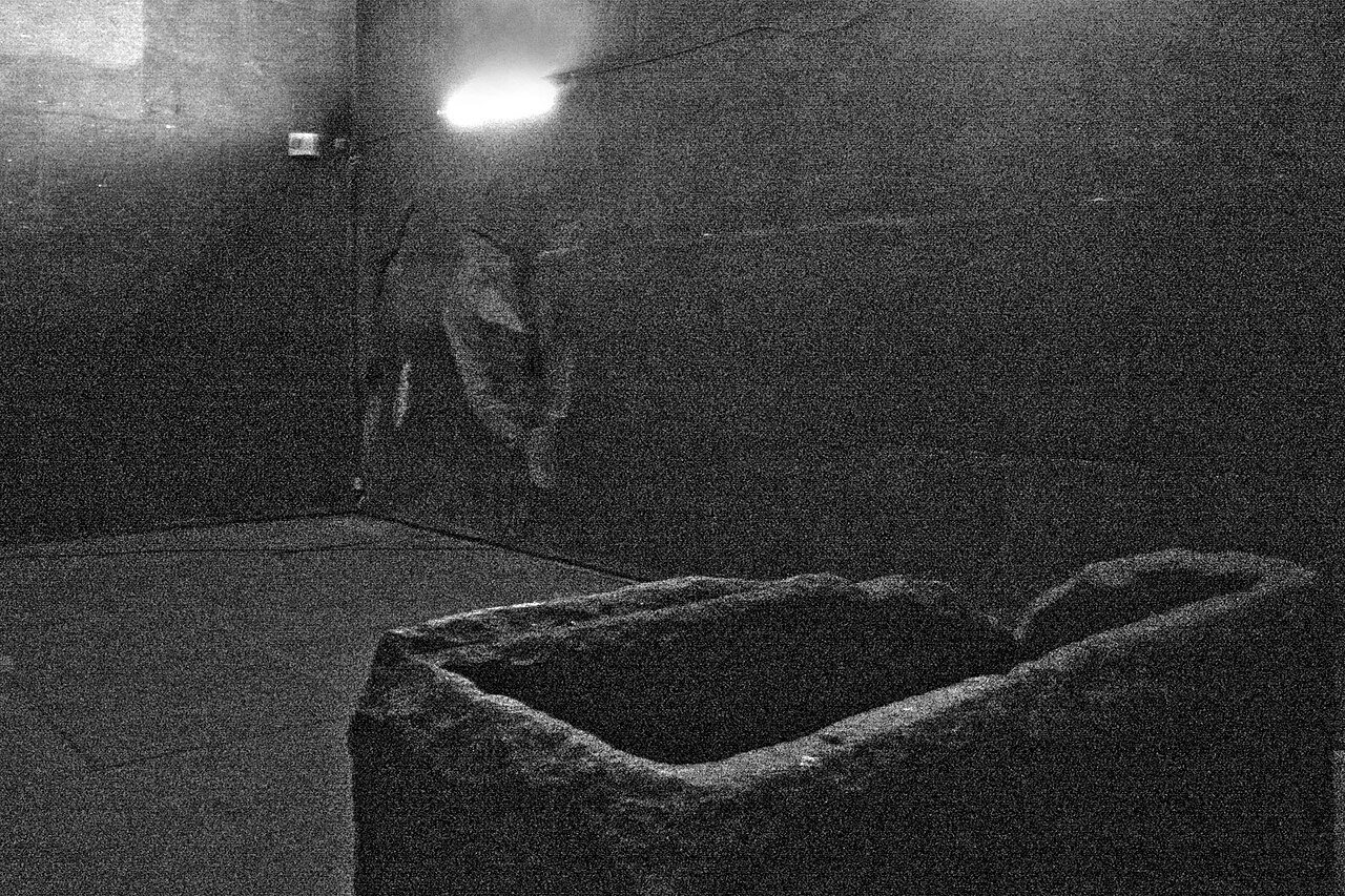 Inside the King's Chamber: granite walls and the open granite box against the west wall, where the blast left it